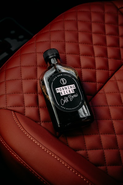 Black and silver jack daniels bottle of red leather fabric
